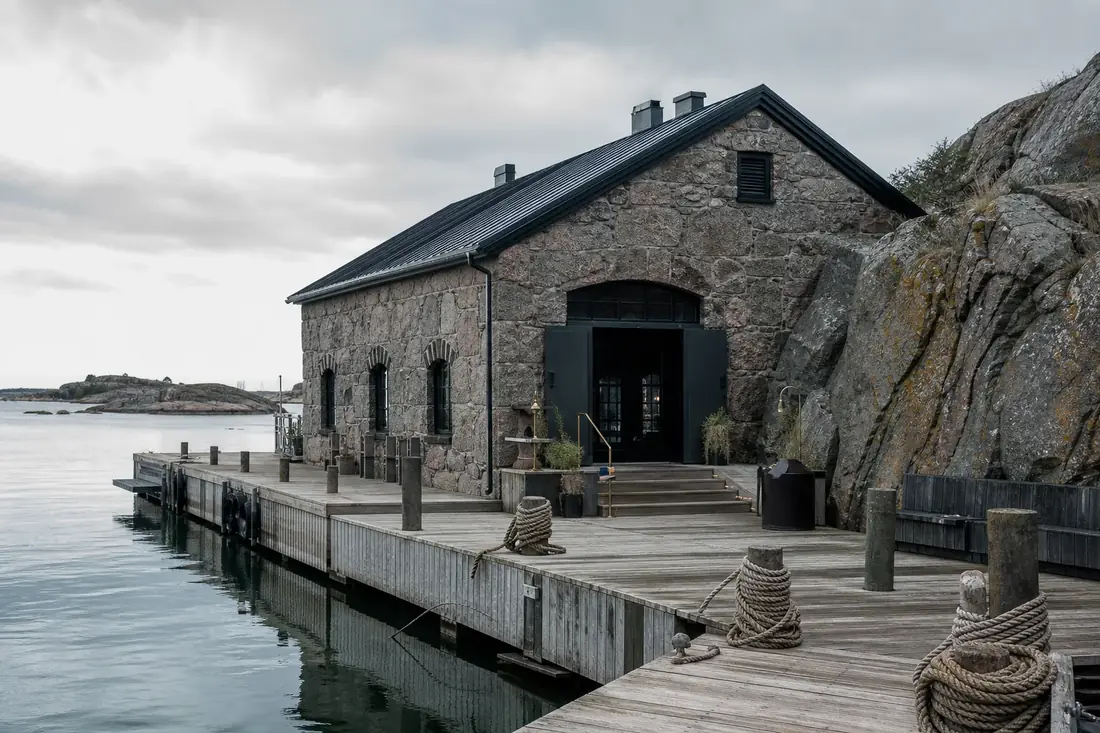 Historic stone warehouse and harbour at Halla Saari, restored as part of the resort
